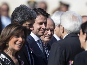 Italian Premier Giuseppe Conte, 3rd from left, is flanked by, from left, Senate President Maria Elisabetta Alberti Casellati, President of the Lower Chamber Roberto Fico and Italian President Sergio Mattarella, right, during celebrations for Italy's Republic Day, in Rome Saturday, June 2, 2018. At an oath-taking ceremony in the presidential palace atop Quirinal Hill, the new premier, political novice Giuseppe Conte, and his 18 Cabinet ministers pledged their loyalty to the Italian republic and to the nation's post-war constitution in front of President Sergio Mattarella.