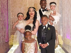 In this photo provided by Morris Claiborne, New York Jets cornerback Morris Claiborne celebrates his wedding with wife Jennifer and family on March 24, 2018, in Irving, Texas. Claiborne is holding twin daughter Ma'Kaila while Jennifer is holding twin daughter Ma'Liah. Also in the photo are Claiborne's son Morris, front right, and daughter Madicyn.