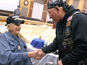 Retired Army Capt. Martin Gelb, 98, shakes hands with retired Marine Tim McCarthy in Derry, New Hampshire, on Monday, June 25, 2018. Gelb was presented with the Congressional Gold Medal for his World War II service with the Office of Strategic Services, the precursor to the Central Intelligence Agency.