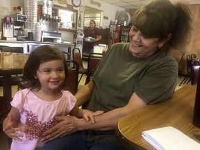 In this May 24, 2018 photo Kelly DeLong, 55, right, owner of Kelly' Cafe in Loco Hills, N.M., plays with her grandniece Annabelle Wilson, 3, at the cafe. Now that Rep. Steve Pearce, R-Hobbs, is stepping down to run for New Mexico governor, eyes are turning to southern New Mexico where the open congressional seat that in recent years has leaned Republican could determine which party controls the U.S. House of Representatives.