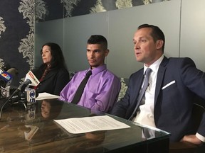 Jose Conde, center, listens to news media while seated between his mother, Rosa Conde, and attorney Bret Royle at Royle's office in Phoenix on Thursday, June 14, 2018. Recently released Mesa police videos show officers punching Conde, who was unarmed, and later mocking him while was lying on a hospital room floor after his Jan. 28 arrest.