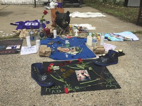 A memorial has been set up Monday, June 25, 2018 in a north Minneapolis alley where a black man was shot and killed by Minneapolis police. Authorities say Thurman Blevins Jr., 31, had a gun and was shot by officers on Saturday, June 23, 2018, after a foot chase.