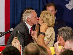 Following his victory in the primary runoff election, South Carolina Gov. Henry McMaster kisses his wife, Patty McMaster, at Spirit Communications Park, Tuesday, June 26, 2018, in Columbia, S.C.