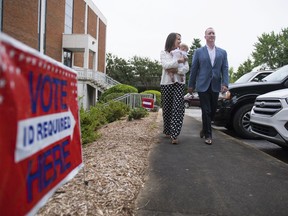 Republican Candidate for Governor, John Warren, and his wife, Courtney, leave their polling place in Greenville, S.C., after voting in the primary elections on Tuesday, June 12, 2018.