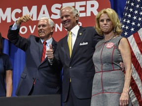 Vice President Mike Pence, left, shows support for Gov. Henry McMaster, accompanied by Peggy McMaster in the William-Brice Kimbel Arena on the Coastal Carolina campus Saturday, June 23, 2018, in Conway, S.C.