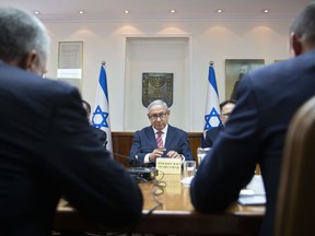 Israeli Prime Minister Benjamin Netanyahu, center, attends the weekly cabinet meeting at the Prime Minister's office in Jerusalem Sunday, June 3, 2018