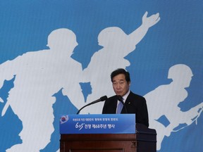 South Korean Prime Minister Lee Nak-yon speaks during a ceremony to mark the 68th anniversary of the outbreak of the Korean War in Seoul, South Korea, Monday, June 25, 2018. Lee said the rival Koreas are discussing the relocation of North Korea's long-range artillery systems away from the tense Korean border. The signs read: "A ceremony of the 68th anniversary of the Korean War."