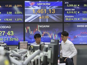 Currency traders watch monitors at the foreign exchange dealing room of the KEB Hana Bank headquarters in Seoul, South Korea, Tuesday, June 19, 2018. Asian stocks tumbled Tuesday after U.S. President Donald Trump escalated a dispute with Beijing over technology policy by threatening a tariff hike on additional Chinese goods.