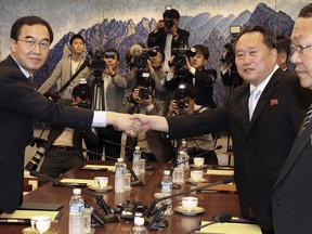 South Korean Unification Minister Cho Myoung-gyon, left, shakes hands with the head of North Korean delegation Ri Son Gwon during their meeting inside the Peace House at the southern side of Panmunjom in the Demilitarized Zone, South Korea, Friday, June 1, 2018. North and South Korea on Friday resumed senior-level peace talks Seoul sees as an important step in building trust with Pyongyang amid a U.S.-led diplomatic push to persuade the North to give up its nuclear weapons. (Korea Pool/Yonhap via AP)