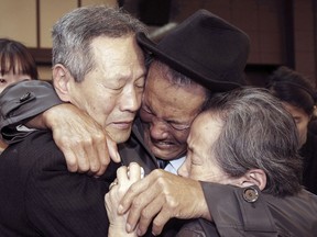 FILE - In this Oct. 22, 2015, file photo, North Korean Son Kwon Geun, center, weeps with his South Korean relatives as he bids farewell after the Separated Family Reunion Meeting at Diamond Mountain resort in North Korea. North and South Korean officials are meeting to map out details for what would be a highly emotional reunion of families separated since the 1950-53 Korean War. (Korea Pool Photo via AP, File)