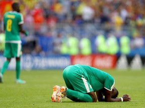 Senegal midfielder Salif Sane bemoans his team's elimination at the World Cup on June 28.