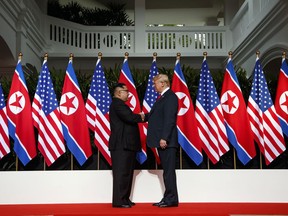 President Donald Trump shakes hands as he meets with North Korean leader Kim Jong Un on Sentosa Island, Tuesday, June 12, 2018, in Singapore.