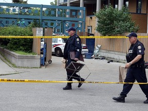 Toronto Police remain on scene at Bradham Path and Birmingham St. after a man in his forties was shot an killed in Toronto on Wednesday June 6, 2018.