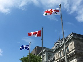 Flags fly outside of Montreal City Hall on Thursday, June 7, 2018.