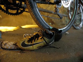 A pair of soccer shoes are left next to bicycles from a group of missing boys at the entrance of a deep cave in Chiang Rai, northern Thailand, Monday, June 25, 2018. Officials say multiple attempts to locate the 12 boys and their soccer coach missing in a flooded cave in northern Thailand for nearly two days have failed, but that they will keep trying.
