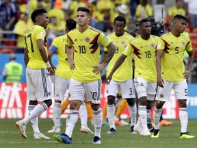 Colombia's James Rodriguez, front, and his teammates walk on the poitch after the group H match between Colombia and Japan at the 2018 soccer World Cup in the Mordavia Arena in Saransk, Russia, Tuesday, June 19, 2018.