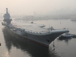 In this May 13, 2018, file photo provided by China's Xinhua News Agency, China's new indigenous aircraft carrier lifts anchor in Dalian in northeast China's Liaoning Province.