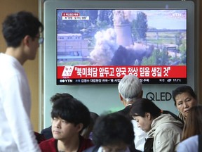 A TV screen shows file footage of the demolition of the cooling tower at a reactor complex in Yongbyon, North Korea, on June 27, 2008 during a news program at the Seoul Railway Station in Seoul, South Korea, Sunday, May 13, 2018.