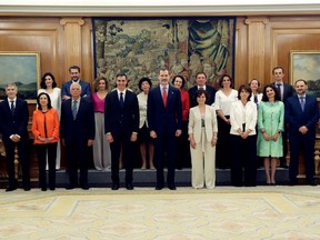 Spain's King Felipe, centre, poses with the members of the new Socialist government of Prime Minister Pedro Sanchez, centre left, after taking their positions during a swearing in ceremony at the Zarzuela Palace in Madrid, Spain, Thursday, June 7, 2018. The government cabinet with most female ministers in Spanish and European history was sworn in Thursday, putting the cap on one of the fastest power transitions in the country's four decades of democratic rule.