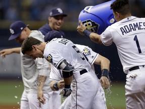 Tampa Bay Rays' Matt Duffy (5) gets doused with water by Willy Adames (1) after hitting the game-winning RBI single off Toronto Blue Jays relief pitcher Ryan Tepera in the ninth inning of a baseball game Wednesday, June 13, 2018, in St. Petersburg, Fla. The Rays won the game 1-0.