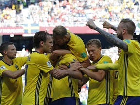 Sweden's Andreas Granqvist, centre, celebrates with teammates after scoring the opening goal during the group F match between Sweden and South Korea at the 2018 soccer World Cup in the Nizhny Novgorod stadium in Nizhny Novgorod, Russia, Monday, June 18, 2018.