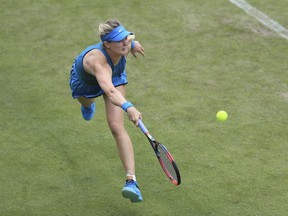 Canada's Eugenie Bouchard plays a shot in her first round tennis match with Jennifer Brady during day one of the Nature Valley Classic at Edgbaston Priory, Birmingham, England, Monday June 18, 2018.