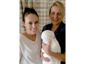 In this photo released by the Office of the Prime Minister of New Zealand, Prime Minster Jacinda Ardern, left, and midwife Libby, no surname given, pose with Ardern's newborn daughter at the Auckland City Hospital in Auckland, New Zealand Friday, June 22, 2018. Ardern on Thursday became just the second elected world leader to give birth while holding office. (Office of the Prime Minister of New Zealand via AP)