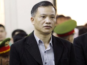 FILE - In this April 5, 2018, file photo, prominent human rights lawyer Nguyen Van Dai stands trial in Hanoi, Vietnam. Vietnamese authorities released from prison and expelled Dai and another dissident, both of whom were sent to Germany, a pro-democracy group said.