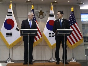 U.S. Defense Secretary Jim Mattis, left, and South Korean Defense Minister Song Young-moo speak in Seoul, South Korea Thursday, June 28, 2018.