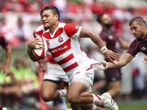 Japan's Lemeki Lomano Lava, left, scores a try in the last half of a rugby test against Georgia in Toyota, central Japan Saturday, June 23, 2018. (Kyodo News via AP)