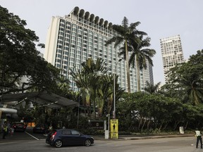 In this Saturday, June 2, 2018, file photo, police officers conduct security checks outside the Shangri-la hotel during the 17th International Institute for Strategic Studies (IISS) Shangri-la Dialogue, an annual defence and security forum in Asia, in Singapore.