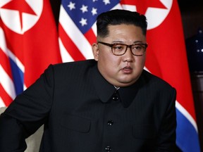 FILE - In this June 12, 2018, file photo, North Korean leader Kim Jong Un listens to U.S. President Donald Trump during a meeting on Sentosa Island in Singapore. Chinese state media say North Korean leader Kim will make a two-day state visit starting Tuesday, June 19.  Kim's trip follows his groundbreaking summit with President Donald Trump in Singapore last week that resulted in a surprise announcement of a U.S. suspension of military drills with its South Korean ally.