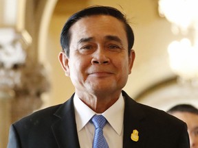 FILE - In this April 19, 2018, file photo, Thailand's Prime Minister Prayuth Chan-ocha arrives for a meeting in Bangkok, Thailand. Prayuth has said that his military government would hold elections only after a coronation ceremony for the new Thai king takes place, casting fresh doubt on promises the polls will be held by February next year.