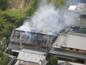 Smoke rises from a house blaze in Takatsuki, Osaka, following an earthquake Monday, June 18, 2018.  A strong earthquake shook the city of Osaka in western Japan on Monday morning, causing scattered damage including broken glass and partial building collapses. There were no immediate reports of injuries.