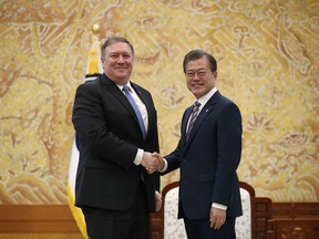 U.S. Secretary of State Mike Pompeo, left, poses with South Korean President Moon Jae-in for a photo during a bilateral meeting at the presidential Blue House in Seoul, South Korea Thursday, June 14, 2018.