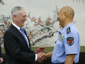 U.S. Defense Secretary Jim Mattis, left, is welcomed by China's Vice Chairman of the Central Military Commission Xu Qiliang at the Bayi Building in Beijing Thursday, June 28, 2018.