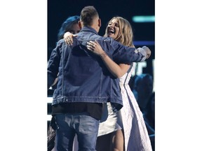 Kane Brown, left, and Lauren Alaina embrace after accepting the collaborative video of the year award at the CMT Music Awards at the Bridgestone Arena on Wednesday, June 6, 2018, in Nashville, Tenn.