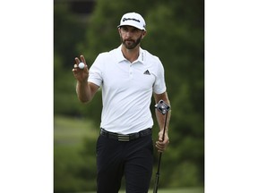 Dustin Johnson gestures towards fans after finishing the ninth hole during the first round of the S. Jude Classic golf tournament in Memphis, Tenn., Friday, June 8, 2018.