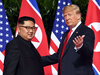 North Korean leader Kim Jong Un and U.S. President Donald Trump meet at the start of their historic summit, at the Capella Hotel on Sentosa island in Singapore on June 12, 2018.