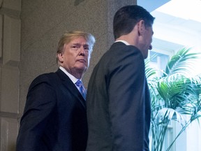 President Donald Trump, accompanied by House Speaker Paul Ryan of Wis., arrives on Capitol Hill in Washington, Tuesday, June 19, 2018, to rally Republicans around a GOP immigration bill.