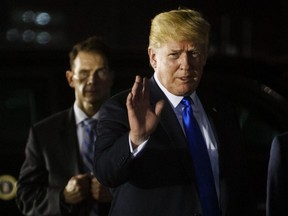 In this Sunday, June 10, 2018, file photo, U.S. President Donald Trump arrives at Paya Lebar Air Base for a summit with North Korean leader Kim Jong Un.