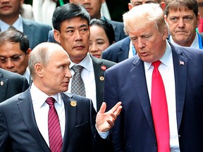 In this Nov. 11, 2017, file photo,  President Donald Trump, right, and Russia President Vladimir Putin talk during the family photo session at the APEC Summit in Danang.