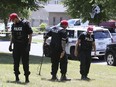 Police investigate at the scene of a double murder on Castlepoint Drive near Highway 27 and Martin Grove Rd., on Friday June 29, 2018.