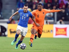 Italy's Davide Zappacosta and Netherlands' Georginio Wijnaldum vie for the ball during the friendly soccer match between Italy and The Netherlands at the Allianz Stadium in Turin, Italy, Monday, June 4, 2018