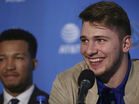 Luka Doncic speaks while he is introduced with Jalen Brunson, left, by the Dallas Mavericks to reporters in Dallas on Friday, June 22, 2018.