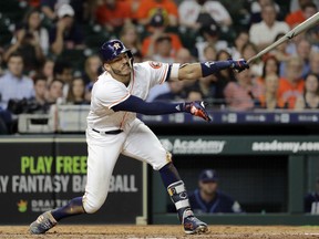 Houston Astros' Carlos Correa strikes out swinging against the Tampa Bay Rays during the eighth inning of a baseball game Tuesday, June 19, 2018, in Houston.