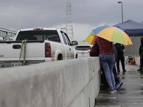 Immigrants from Guatemala and Cuba seeking asylum wait at a port of entry, Wednesday, June 20, 2018, in Matamoros, Mexico. Nearly 2,000 children have been separated from their families at the U.S. border over a six-week period during a crackdown on illegal entries, according to Department of Homeland Security figures obtained Friday by The Associated Press.