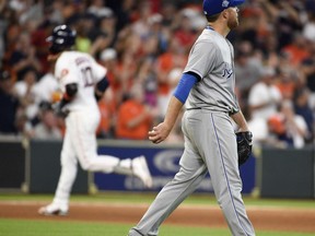 Kansas City Royals starting pitcher Ian Kennedy, right, walks off the mound as Houston Astros' Yuli Gurriel, back left, rounds the bases after hitting a solo home run during the fourth inning of a baseball game, Saturday, June 23, 2018, in Houston.