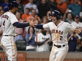 Houston Astros' Alex Bregman (2) celebrates his two-run home run off Toronto Blue Jays relief pitcher Tim Mayza with George Springer during the eighth inning of a baseball game Tuesday, June 26, 2018, in Houston.