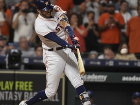 Houston Astros' Carlos Correa hits a walk-off RBI single during the 12th inning of a baseball game against the Kansas City Royals, Saturday, June 23, 2018, in Houston. The Astros won 4-3.